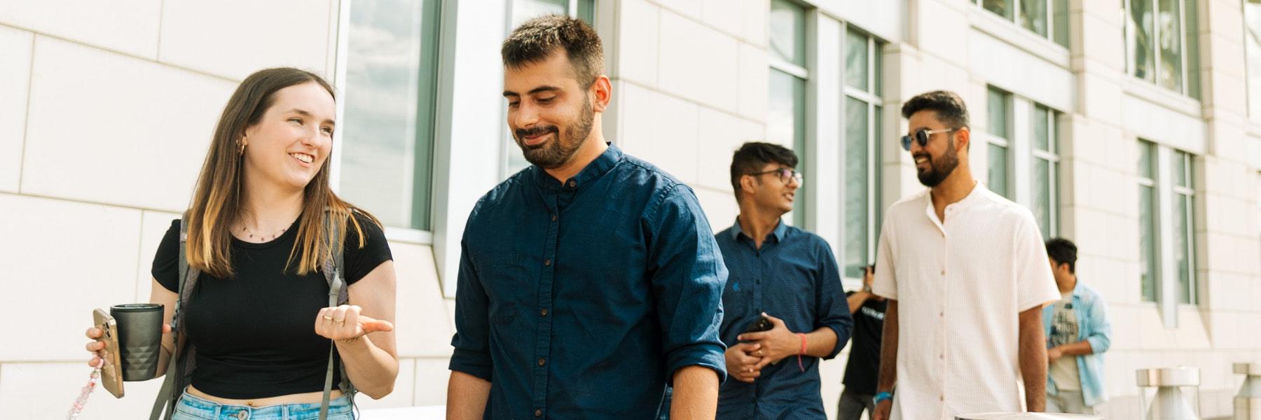 Graduate Students walking outside Campus Center